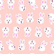 a repeating pattern of white bunny faces on a pink background.