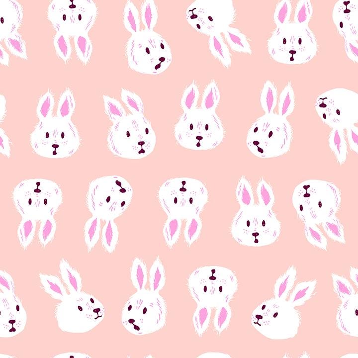 a repeating pattern of white bunny faces on a pink background.