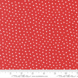 a red fabric with white hearts scattered across it.
