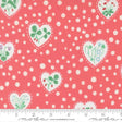 a fabric with a pink background and white polka dots. It has a repeating pattern of hearts and leaves, as well as flowers and berries. The fabric appears to be a fabric with a floral pattern, possibly made of cotton.
