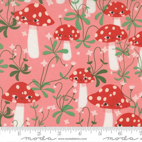 a pattern of red and white spotted mushrooms with green leaves and flowers on a pink background.