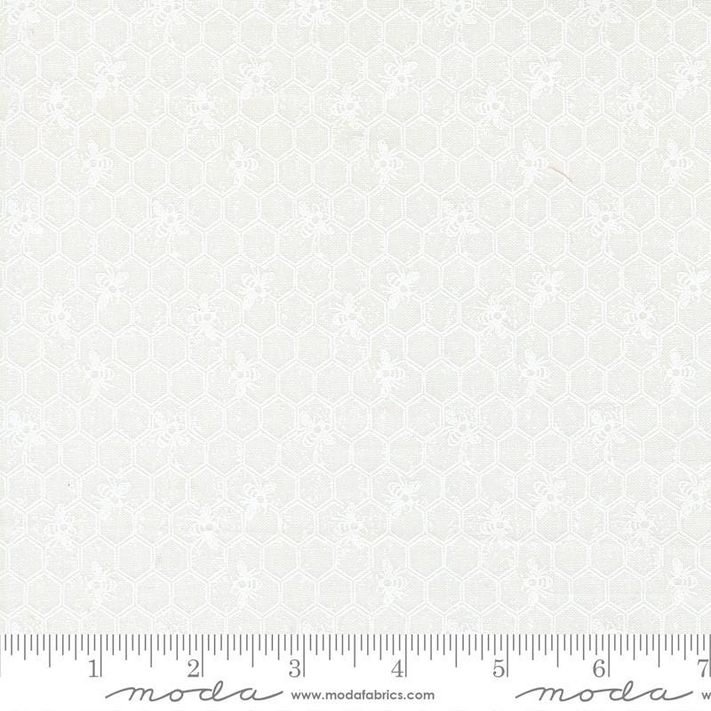 The image is a close-up of a white fabric with a honeycomb pattern.
