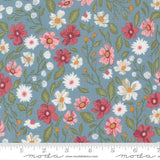 The image is a fabric with a floral pattern featuring various types of flowers in different colors, including red, white, and pink. The flowers are arranged in a repeating pattern, creating a visually appealing and vibrant design.