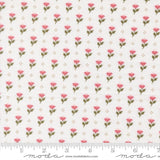 a repeating pattern of pink flowers on a white background, with a ruler for scale at the bottom.