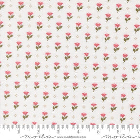 a repeating pattern of pink flowers on a white background, with a ruler for scale at the bottom.
