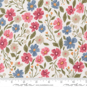 a fabric with a floral pattern of various colored flowers and leaves. The flowers are in shades of pink, blue, and yellow, and the leaves are green and brown. The fabric appears to be a soft, white material with a floral design.