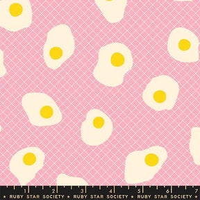 a pattern of white and yellow eggs against a pink background.