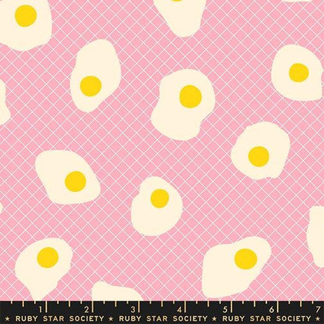 a pattern of white and yellow eggs against a pink background.