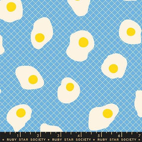 a pattern of white eggs with yellow yolks against a blue background.