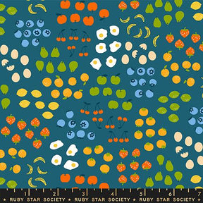 The image is a vibrant collage of various fruits and vegetables, including bananas, apples, oranges, pears, and strawberries, all set against a blue background.