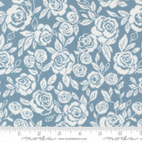 a repeating pattern of white roses against a light blue background.