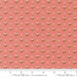 a repeating pattern of pink flowers with green leaves on a fabric surface.