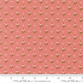 a repeating pattern of pink flowers with green leaves on a fabric surface.