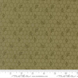 The image is a close-up of a fabric with a repeating pattern of hexagons and small bee images.