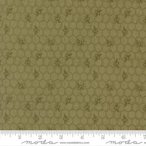 The image is a close-up of a fabric with a repeating pattern of hexagons and small bee images.