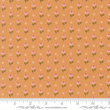 a repeating pattern of small pink flowers on an orange background, with a ruler for scale at the bottom.