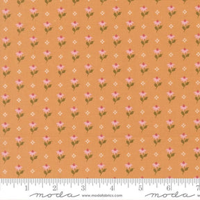 a repeating pattern of small pink flowers on an orange background, with a ruler for scale at the bottom.