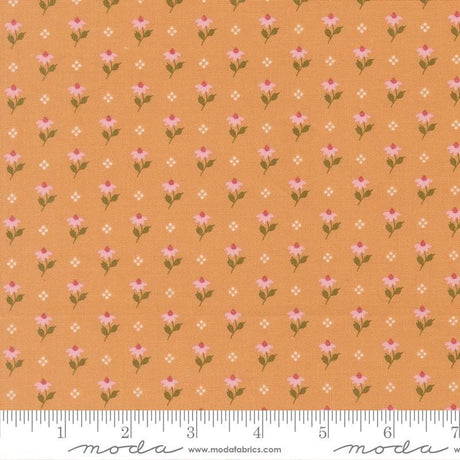 a repeating pattern of small pink flowers on an orange background, with a ruler for scale at the bottom.