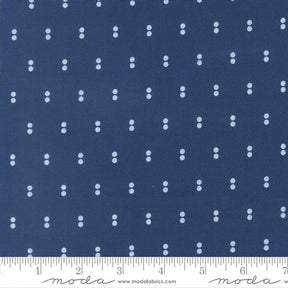 a close-up view of a fabric with a repeating pattern of small white dots on a dark blue background.