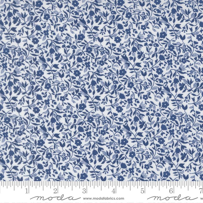 The image is a close-up of a fabric with a blue floral pattern.