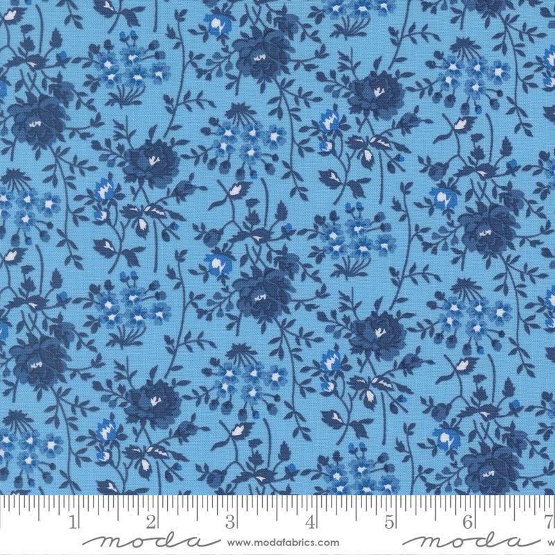 a blue floral pattern with white flowers and leaves.
