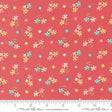 a vibrant red fabric with a repeating pattern of small, colorful flowers in shades of pink, blue, and yellow. The flowers are scattered across the fabric in a random yet visually appealing manner, creating a lively and cheerful design.