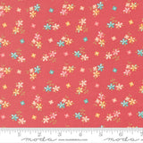 a vibrant red fabric with a repeating pattern of small, colorful flowers in shades of pink, blue, and yellow. The flowers are scattered across the fabric in a random yet visually appealing manner, creating a lively and cheerful design.