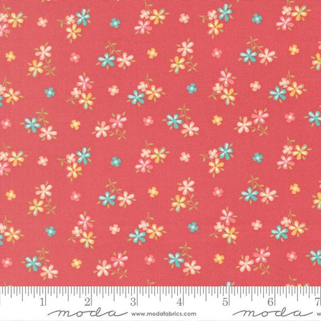 a vibrant red fabric with a repeating pattern of small, colorful flowers in shades of pink, blue, and yellow. The flowers are scattered across the fabric in a random yet visually appealing manner, creating a lively and cheerful design.
