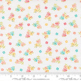 The image is a fabric with a floral pattern, featuring small colorful flowers and leaves scattered across it.