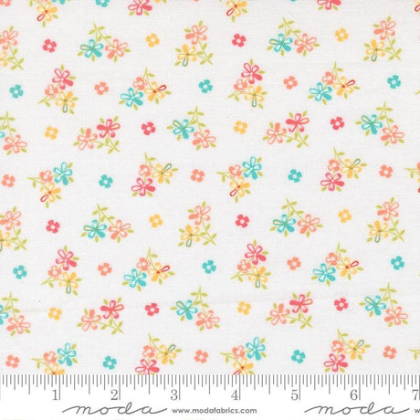 The image is a fabric with a floral pattern, featuring small colorful flowers and leaves scattered across it.