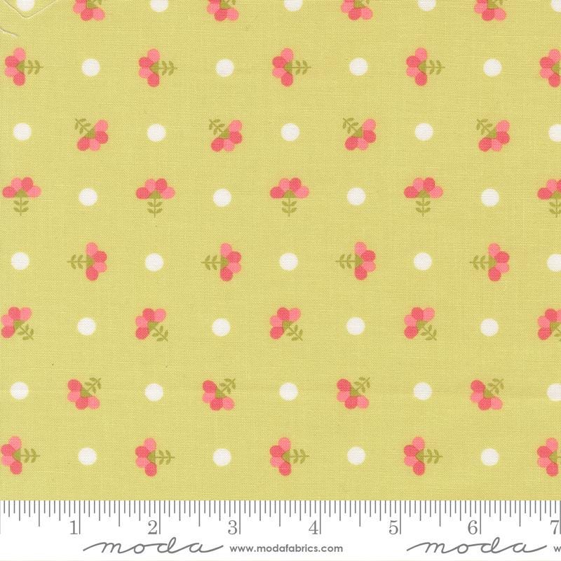 a repeating pattern of small white circles and pink flowers on a yellow background.