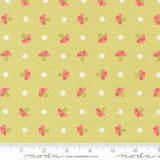 a repeating pattern of small white circles and pink flowers on a yellow background.