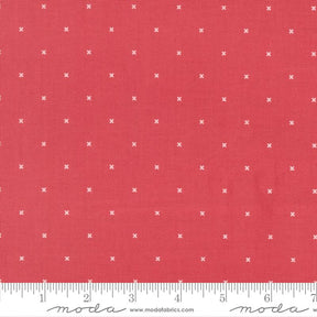 The image is a close-up of a red fabric with white crosses on it.