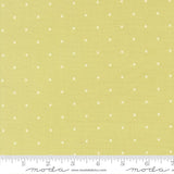 The image is a fabric with a yellow background and white dotted pattern. There is a ruler at the bottom of the image for scale.