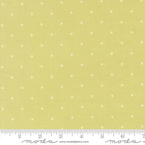The image is a fabric with a yellow background and white dotted pattern. There is a ruler at the bottom of the image for scale.