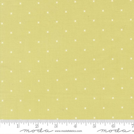 The image is a fabric with a yellow background and white dotted pattern. There is a ruler at the bottom of the image for scale.