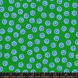 a pattern of blue smiley faces scattered across a green background.