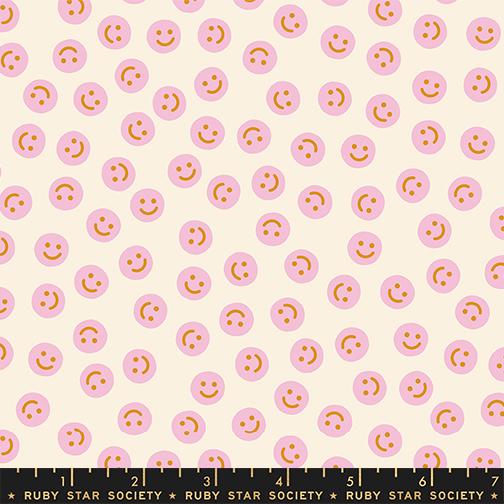 a repeating pattern of pink smiley faces on a light beige background.