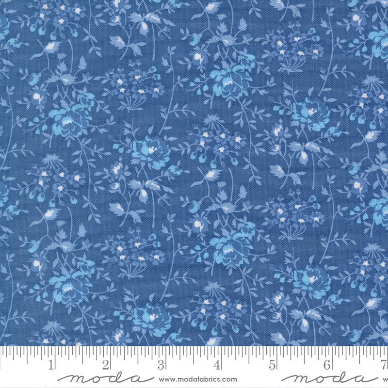 The image is a close-up of a fabric with a blue floral pattern.