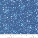 The image is a close-up of a fabric with a blue floral pattern.