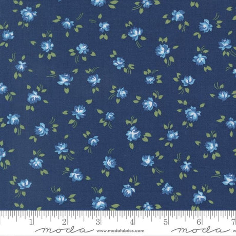 a fabric with a repeating pattern of blue flowers and green leaves on a dark blue background.