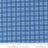a close-up view of a fabric with a blue and white checkered pattern. The fabric appears to be made of a material with a grid-like texture, which creates a visually appealing and textured appearance.