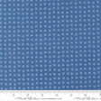 The image is a close-up of a fabric with a blue pattern, featuring small white dots or flowers arranged in a grid-like pattern.