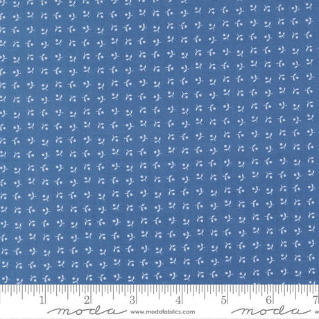 The image is a close-up of a fabric with a blue pattern, featuring small white dots or flowers arranged in a grid-like pattern.