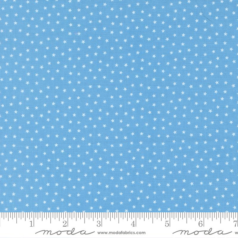 The image is a fabric with a blue background and white stars, and it is described as a fabric with white stars on a blue background.