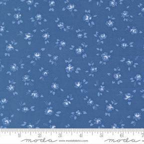 a fabric with a blue floral pattern, featuring small white flowers and leaves scattered across the fabric.