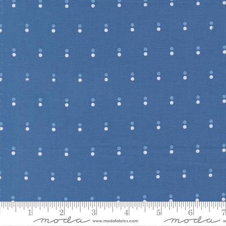 The image is a close-up of a blue fabric with white dots arranged in a diagonal pattern.
