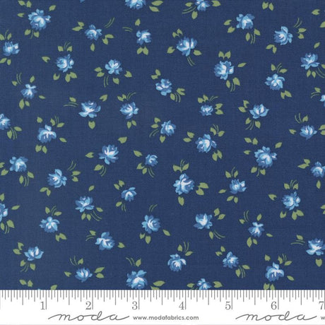 a fabric with a repeating pattern of blue flowers and green leaves on a dark blue background.
