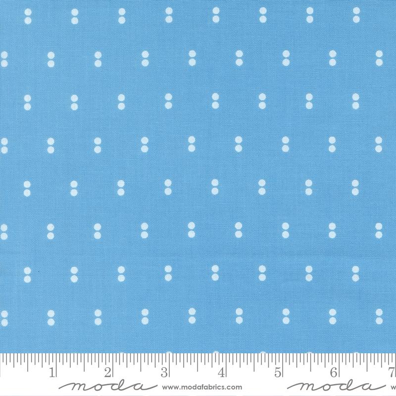 a blue fabric with white dots arranged in a grid pattern.