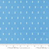 a blue fabric with white dots arranged in a grid pattern.